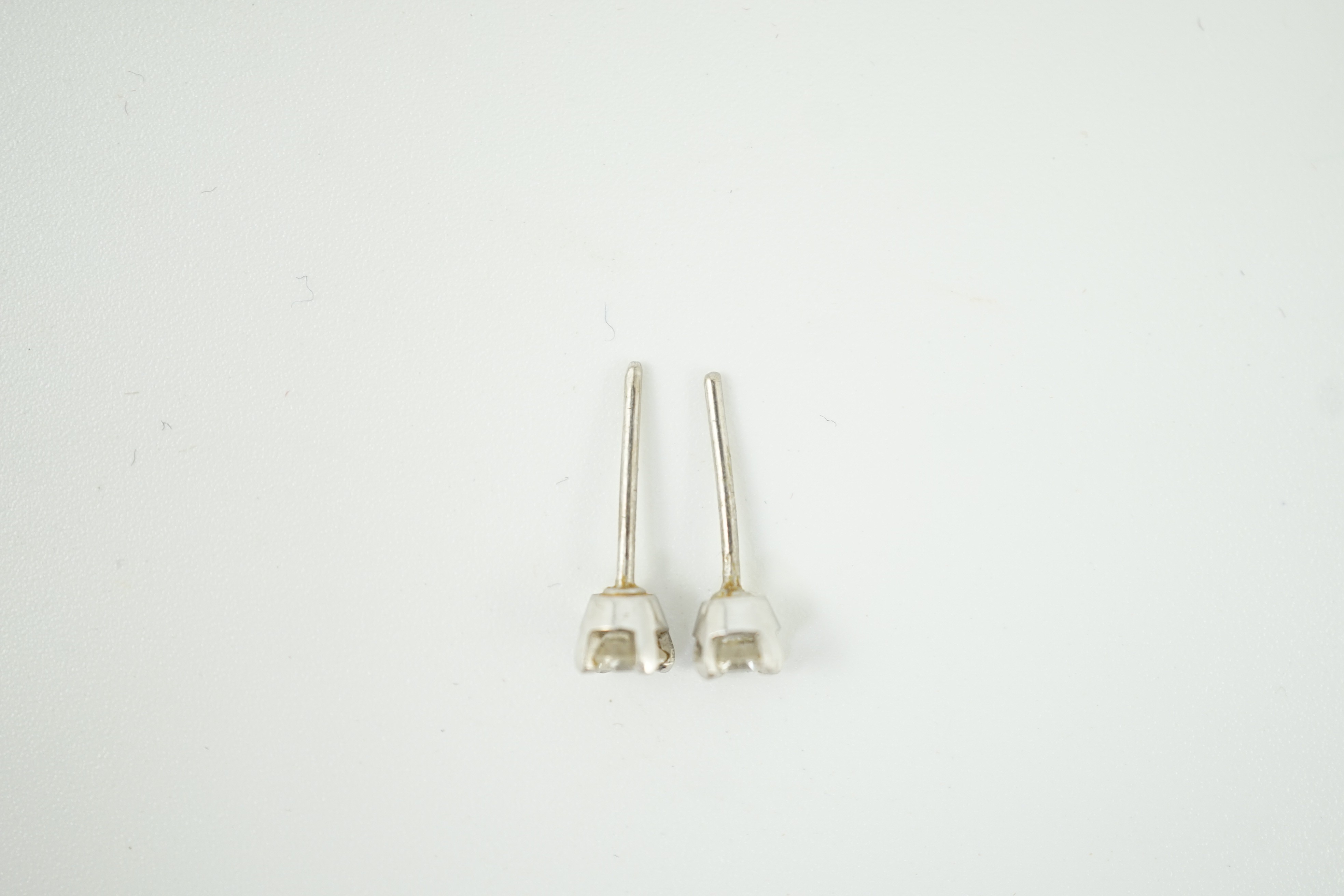 A pair of 9ct white metal and solitaire diamond ear studs, stone diameter approx. 3.4mm, gross weight 0.9 grams.